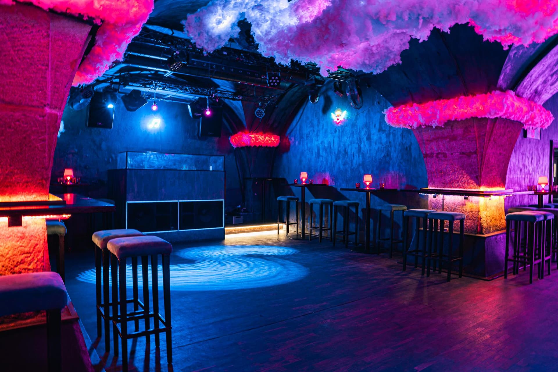 Dance floor and bar seating under glowing clouds