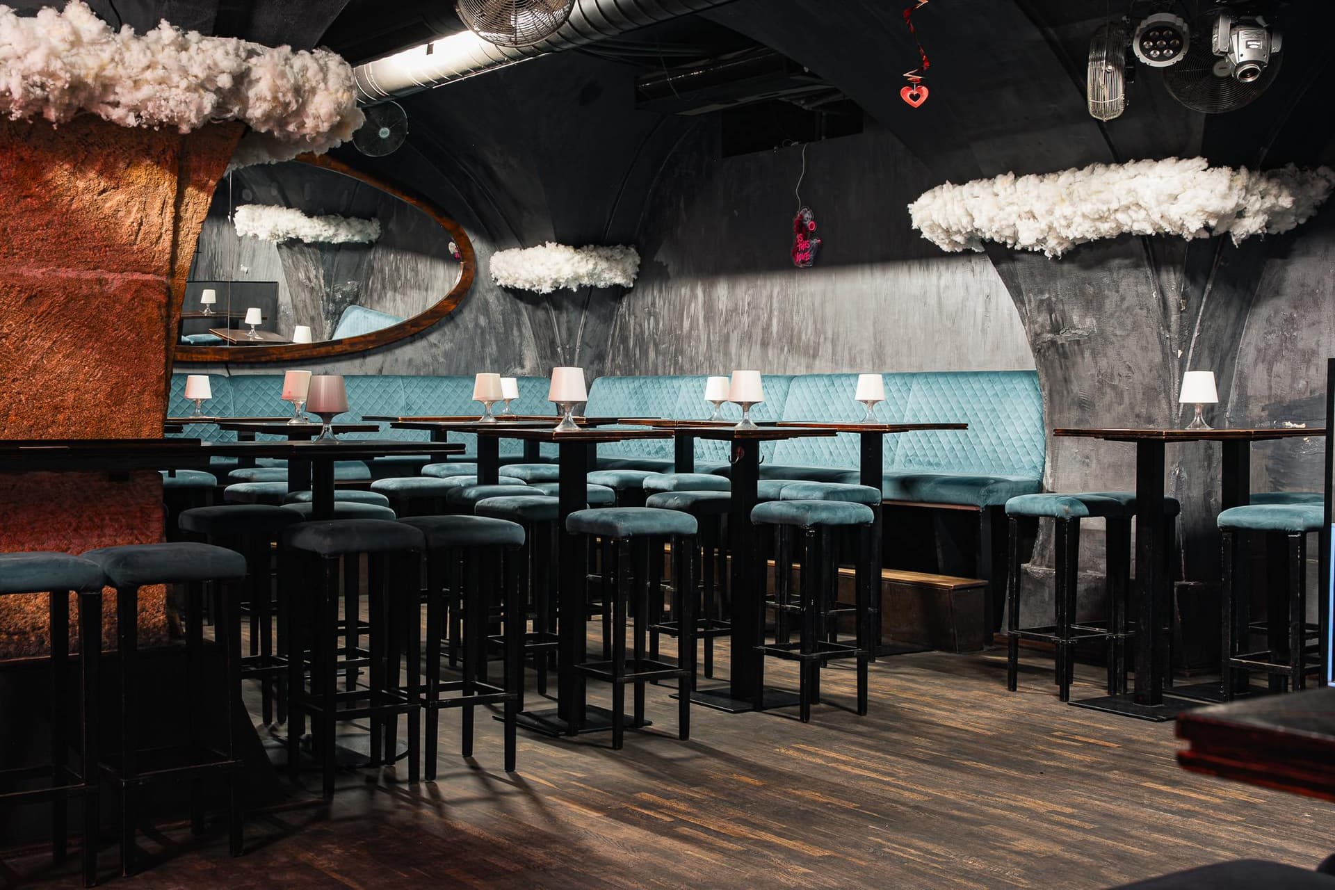 Turquoise banquettes and a copper column in daylight