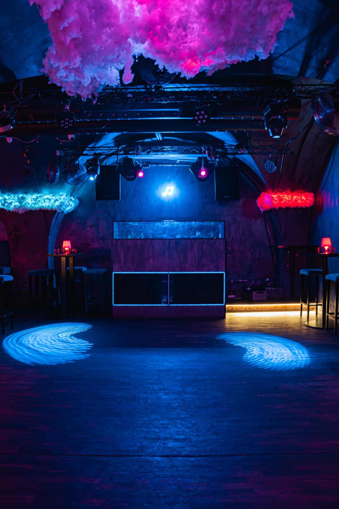 DJ booth and an empty dance floor in blue light